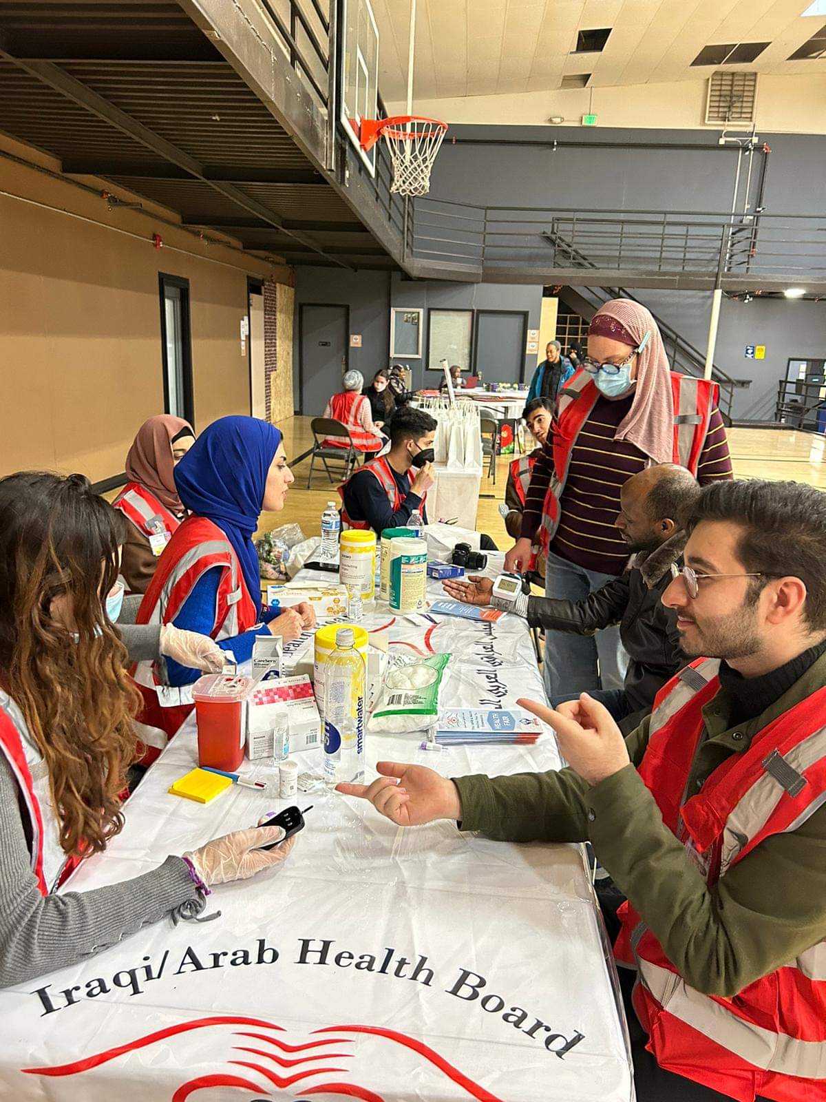 Taking blood pressure/blood sugar at a community health event with the Iraqi Arab Health Board of Washington